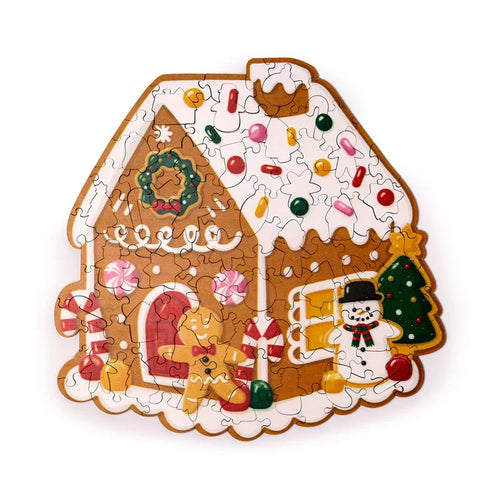 Overhead view of a completed 130-piece colourful wooden Christmas gingerbread house jigsaw puzzle, depicting a wreath, candy canes, a gingerbread man, a snowman, and a Christmas tree.