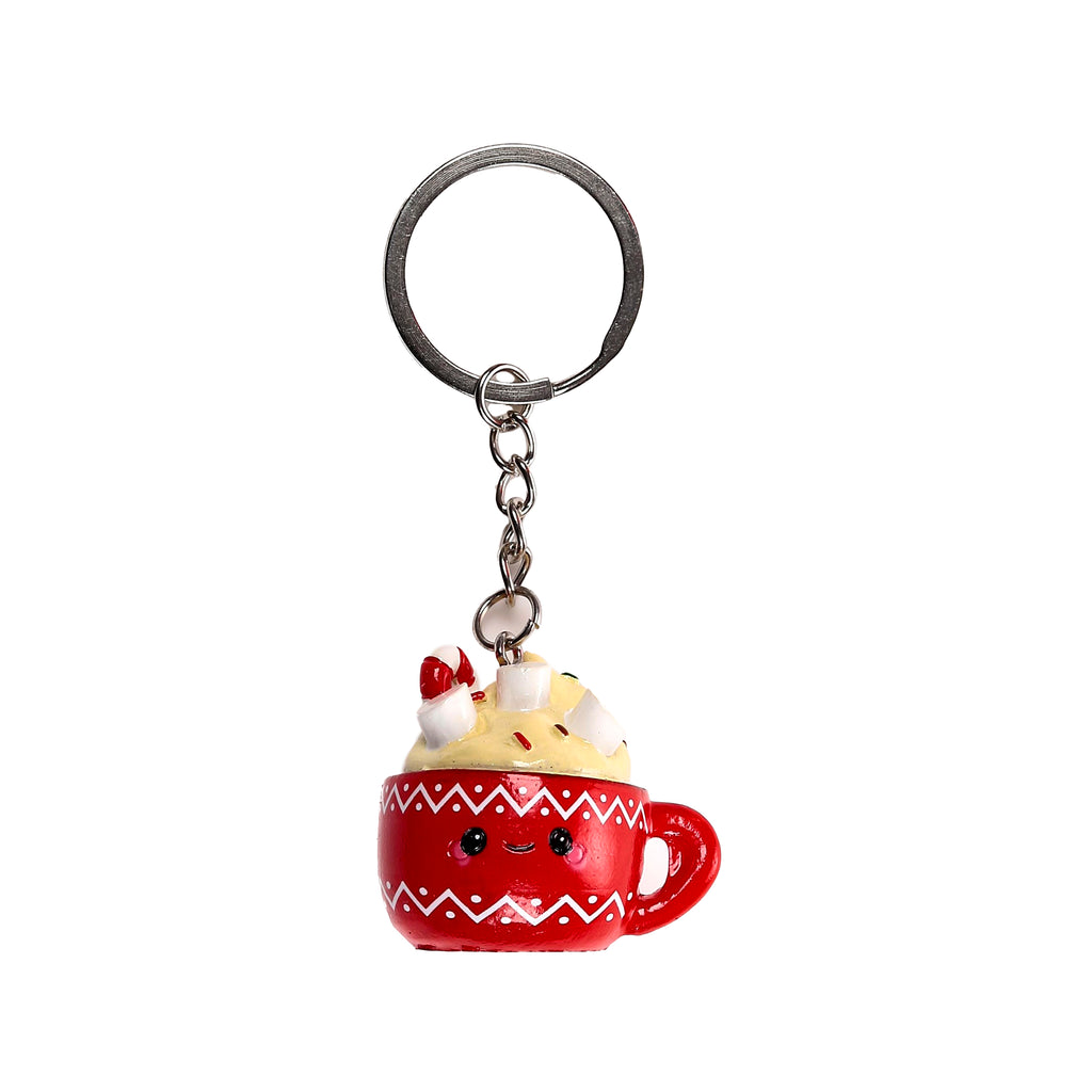 Front view of a red hot chocolate mug keyring, featuring a cute face, white zigzag pattern, and toppings of cream, white marshmallows, and a red candy cane.