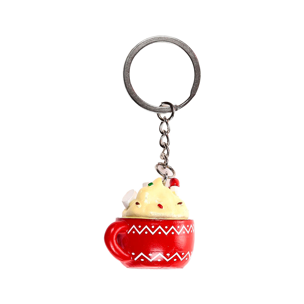Hot chocolate keyring featuring a red mug with white zigzag patterns, topped with cream, white marshmallows, colourful sprinkles, and a red and white striped candy cane, displayed on a white background.