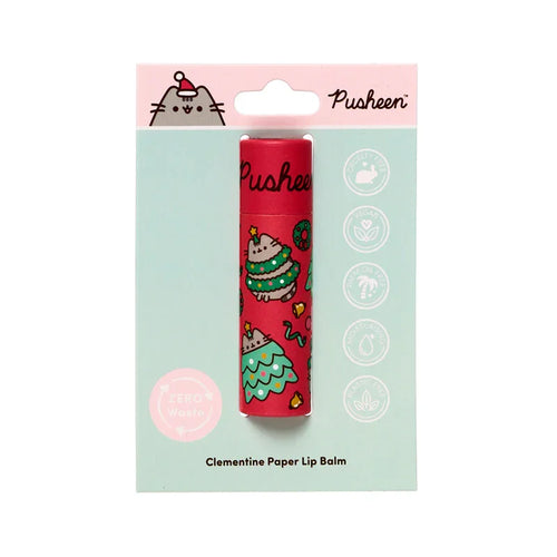 Front view of a Christmas Pusheen the Cat paper stick lip balm. The red paper tube features Pusheen in festive Christmas tree designs. It is presented in mint green packaging, indicating clementine flavour, zero waste, vegan, and plastic-free attributes.