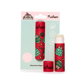 Front view of two red paper stick lip balms featuring Christmas cartoon cat, tree, and bell designs. One lip balm is in light blue card packaging showing 'Zero Waste', and the other is unboxed with its cap off, revealing the white balm stick.