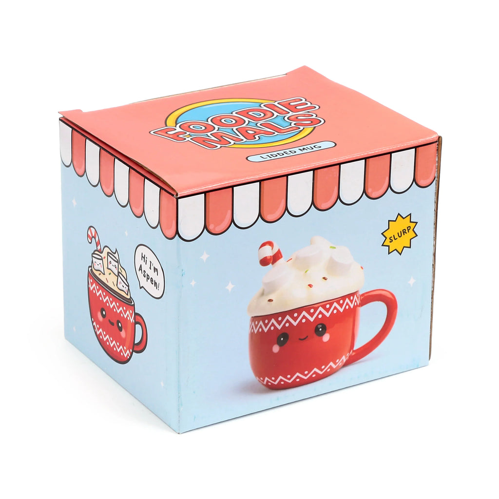Angled view of a light blue and reddish-orange Foodiemals ceramic lidded mug product box, illustrating a red hot chocolate mug with a whipped cream lid and candy cane.