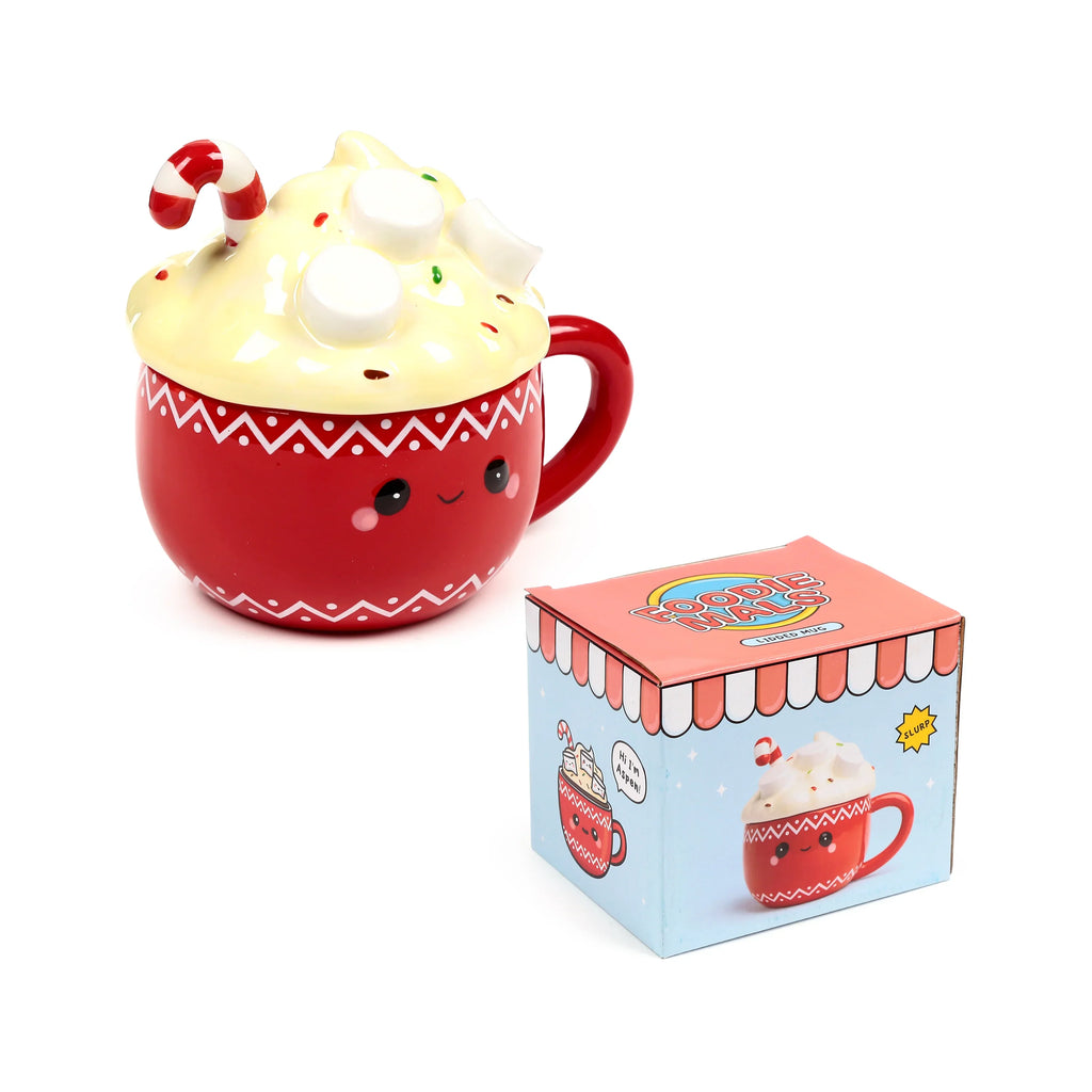 Angled view of a red ceramic lidded mug designed for hot chocolate, featuring a cute cartoon face, white zig-zag patterns, and a cream-coloured lid adorned with marshmallows, colourful sprinkles, and a candy cane. An illustrated product box stands beside it.