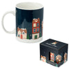 Angled view of a Christmas Village Porcelain Mug, showcasing its dark blue design with colourful snowy houses and festive trees. The white handle and interior are visible, alongside its matching dark blue packaging box.