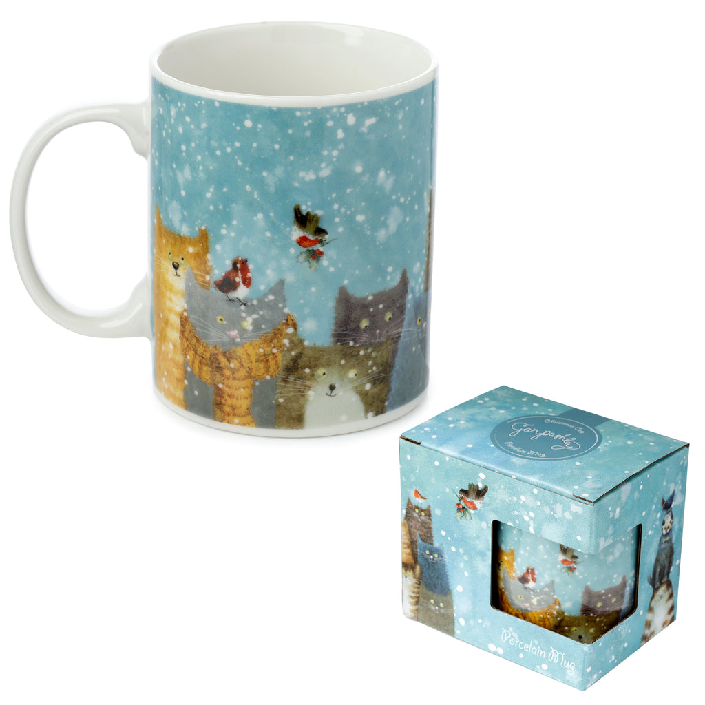 Porcelain mug with Jan Pashley Christmas cats and robins design on a snowy blue background, shown at an angle with its matching gift box.