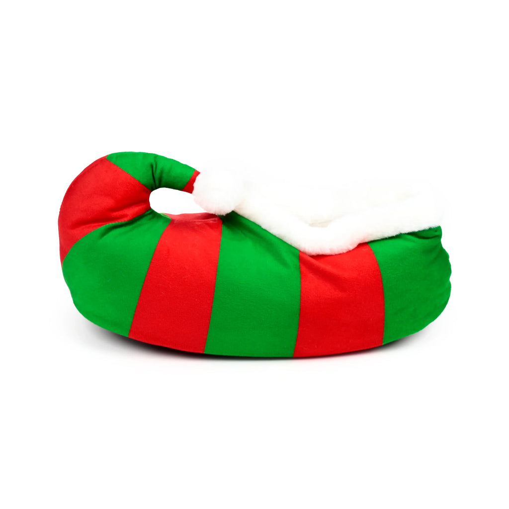 Red and green striped plush elf slipper with a curled toe, white fluffy trim, and a pom-pom, shown in profile.
