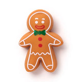 Front view of a brown stretchy Christmas gingerbread man fidget toy, featuring white icing details, a green bow tie, red mouth, white eyes, and red buttons, on a white background.