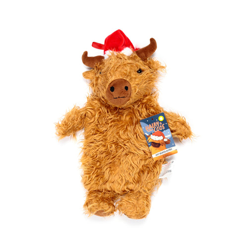 Top-down view of a Christmas Highland Coo hot water bottle, featuring a shaggy brown plush cover, plush brown horns, a snout, and a red Santa hat. A product tag is attached.