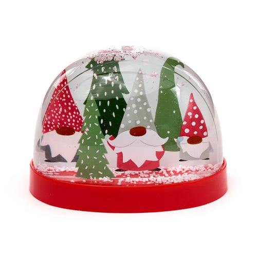 Front view of a Christmas gonk snow globe, featuring four festive gnomes and green trees inside a clear dome, with white snow and shimmering glitter on a red base.