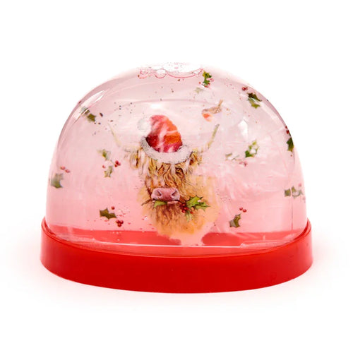 Large collectable Christmas snow globe featuring a festive Highland Coo illustration in a Santa hat, surrounded by holly and a robin, set on a red base.