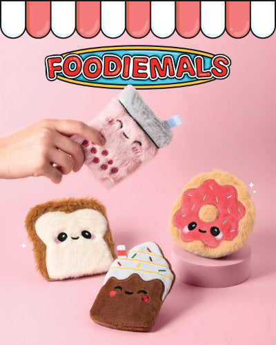 Plush toys resembling food items on a pink background with 'FOODIEMALS' branding.
