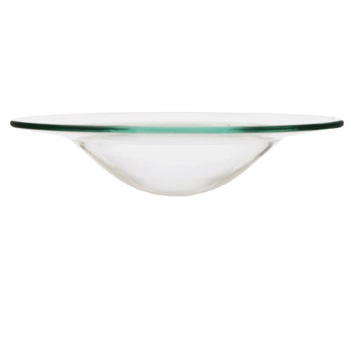 Side view of a transparent glass oil burner dish, featuring a wide flat rim with a subtle greenish tint, and a shallow bowl-shaped centre.