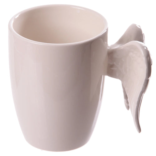 White ceramic mug featuring a sculpted angel wings handle, shown from an angled perspective.