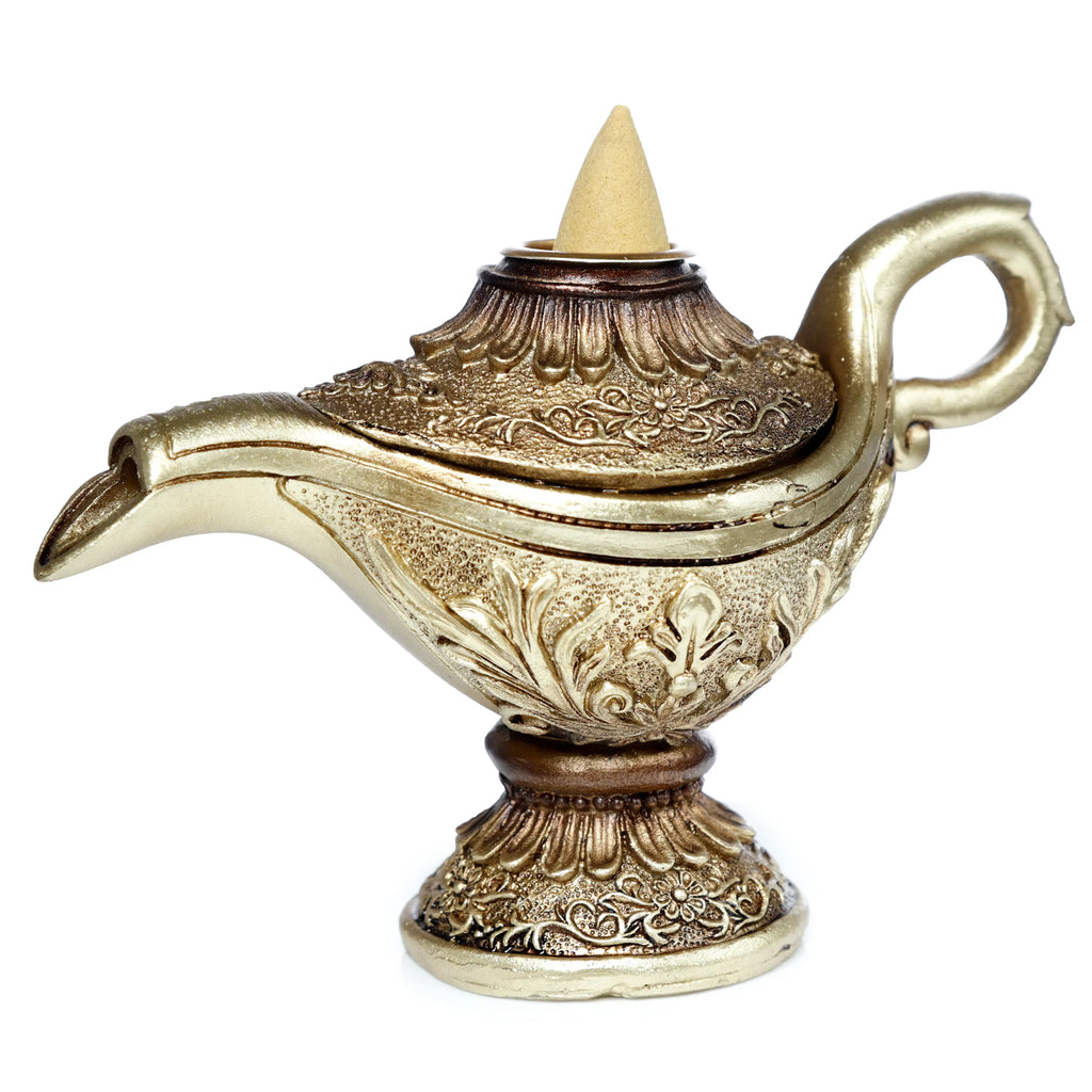 Angled view of a gold and bronze magic lamp backflow incense burner, intricately detailed with a beige incense cone.