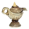 Angled view of an ornate, antique gold-coloured Magic Lamp backflow incense burner with intricate floral patterns, featuring an unlit beige conical incense cone at the top.