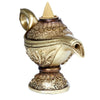 Angled view of a gold-toned magic lamp backflow incense burner, intricately decorated with floral and scrollwork patterns, featuring a handle, spout, and an unlit beige incense cone in its top.