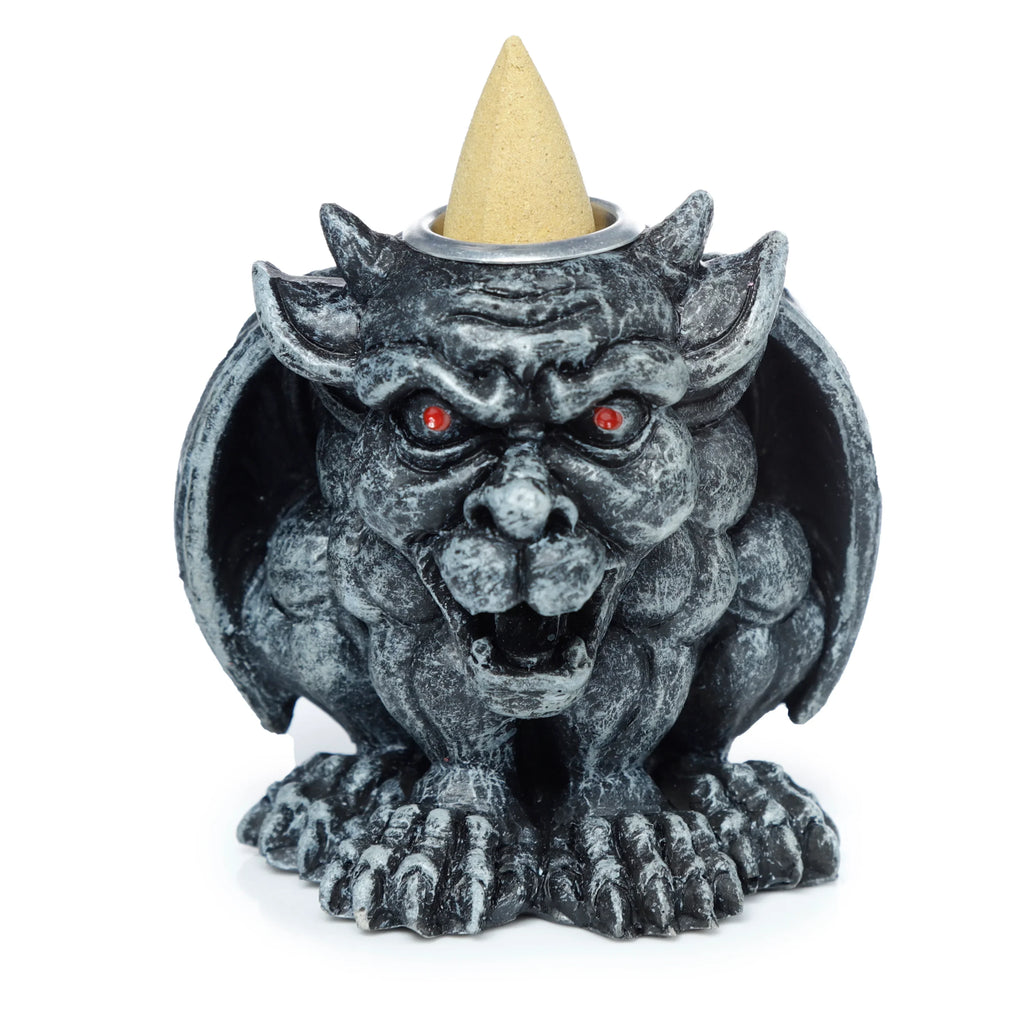 Front view of a dark grey, stone-effect gargoyle incense burner with red eyes. A light beige incense cone rests on its head.