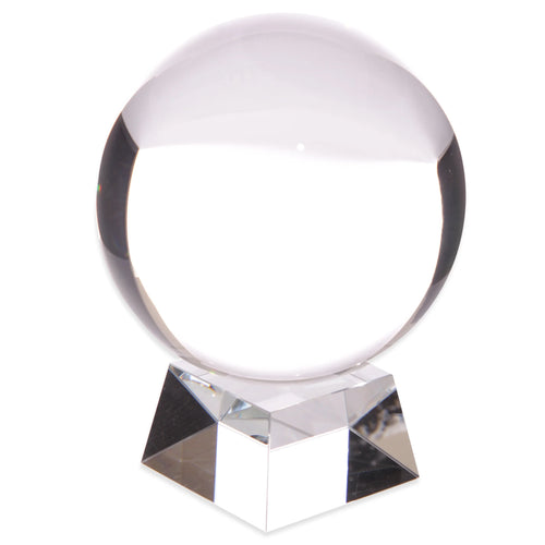 Angled view of a clear spherical crystal ball resting on a faceted glass stand.