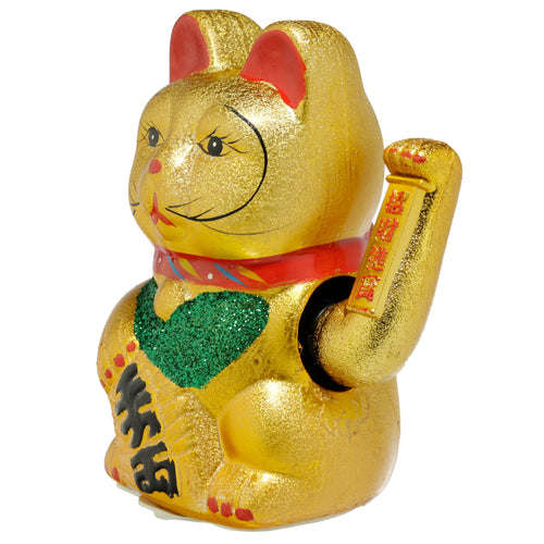 Angled view of a large golden Maneki Neko lucky waving cat, featuring red ears, a green glitter bib, and black and red Japanese characters.