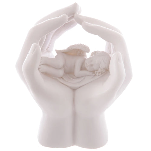White sleeping cherub figurine with subtle golden wings, cradled in cupped hands, shown in a direct view.