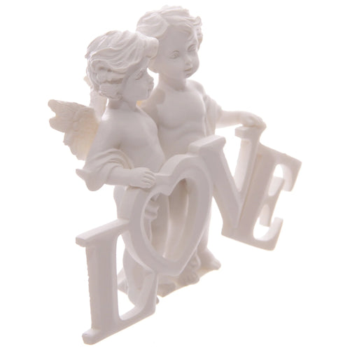 Angled view of a white cherubs figurine, depicting two winged cherubs with sculpted hair holding up the word L-O-V-E in bold capital letters.