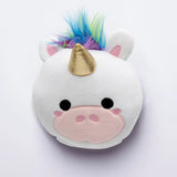 Front view of a white plush unicorn travel pillow, featuring a gold horn, colourful blue, green, and purple faux fur mane, pink ears, and embroidered black eyes with a pink snout.
