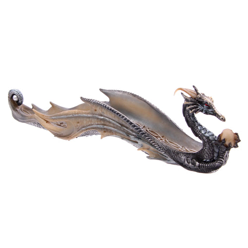 Angled view of a shimmering metallic grey and beige dragon incense stick burner and ashcatcher, intricately detailed with scales, prominent wings, and red eyes.