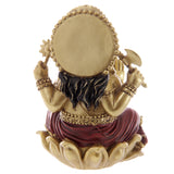 Back view of a gold and red Ganesh statue, featuring a circular halo, dark hair, intricately detailed gold and red clothing, and a gold lotus base.