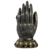 Front view of a decorative black and gold hand figurine, featuring a distressed finish and an ornate base.