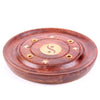 Angled view of a round Sheesham wood incense ashcatcher, featuring a central brass-coloured Yin Yang inlay, surrounding star inlays, and holes for incense sticks.