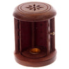 Angled view of a dark brown Sheesham wood barrel-shaped incense cone burner, with its door open revealing a gold-coloured cone holder and perforated reddish-brown interior. The top features a carved floral design.