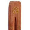 Close-up view of a Sheesham wood ashcatcher incense stick burner, showing a circular gold-coloured symbolic inlay and the central ash collection groove. Two gold-coloured star inlays are visible below.