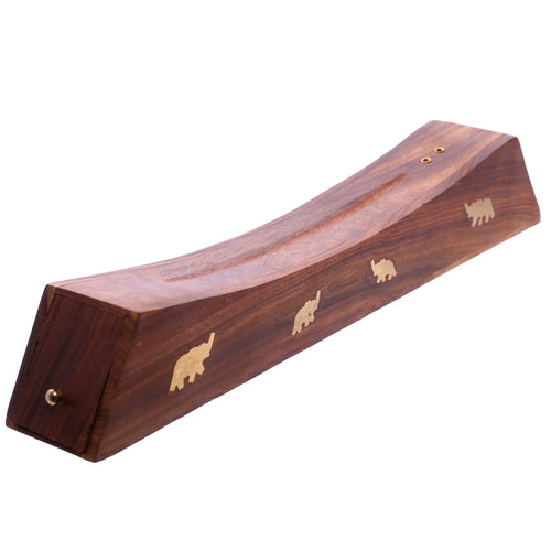 Angled view of a dark Sheesham wood incense stick ashcatcher. It features a curved top and brass elephant inlays along its visible side. Two small brass holes are present for holding incense sticks.