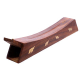 Angled view of a dark brown Sheesham wood incense ashcatcher box. It features a curved top with two brass-coloured holes for incense sticks, and a visible side decorated with golden elephant inlays. The open end for ash collection is also shown.
