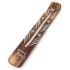 Angled view of a rustic mango wood incense holder, featuring a central ashcatcher groove and white carved elephant and asterisk designs.