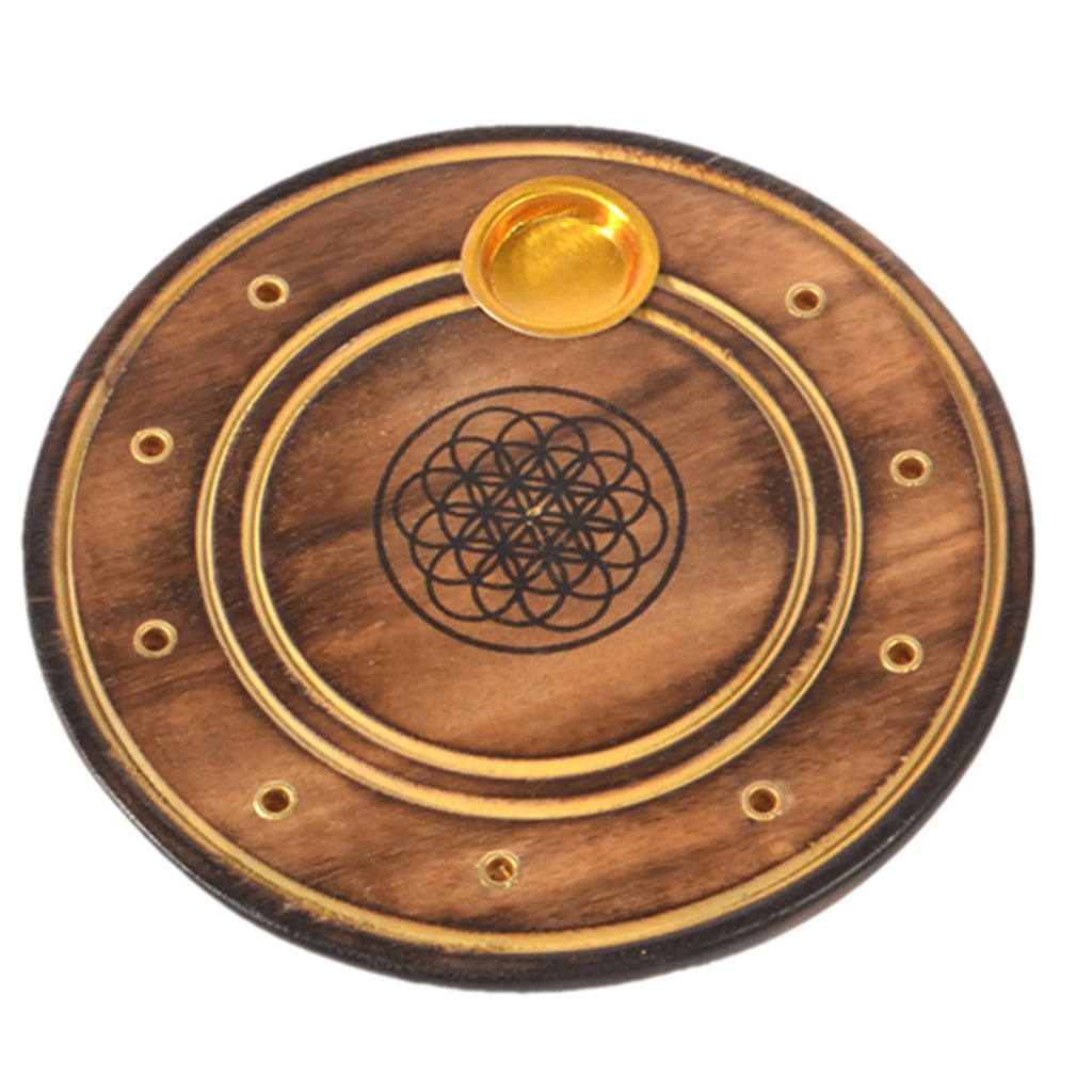 Top-down view of a round, dark brown mango wood incense holder, featuring a black Flower of Life engraving, gold-coloured rings, multiple incense stick holes, and a central cone burner.