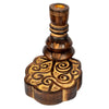 Angled view of a dark brown mango wood backflow incense burner, featuring a turned pillar with a golden incense holder, a tiered middle section, and a carved, lobed base with swirling patterns.
