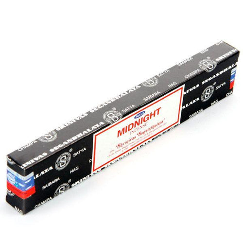 Angled front view of a black rectangular box of Midnight Nag Champa incense sticks, featuring a prominent white label with red borders and MIDNIGHT INCENSE text. The box is adorned with repeating patterns, text, and 'S' logos, with red and blue details visible on one end.