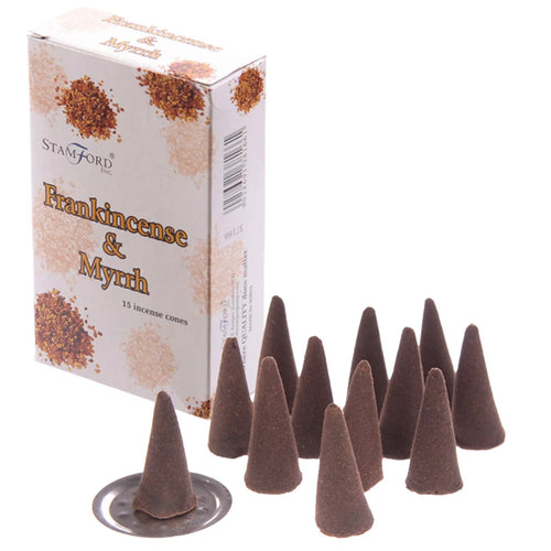 Angled view of a white box of Frankincense & Myrrh incense cones, its front showing product details and a brown speckled design. Arranged in front are multiple dark brown conical incense cones, one resting on a small, round, silver-coloured metal holder.