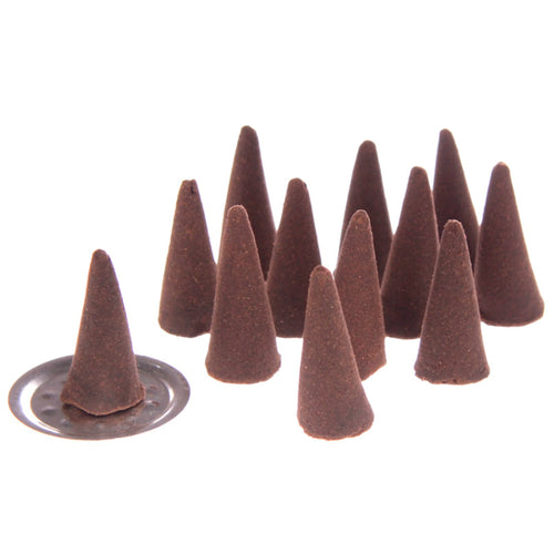 Angled view of multiple dark brown, textured incense cones, with one cone placed upright on a small, round metallic burner, against a plain white background.