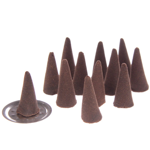 Angled view of multiple dark brown conical sandalwood incense cones, with one cone resting on a silver-coloured burner plate, on a white background.