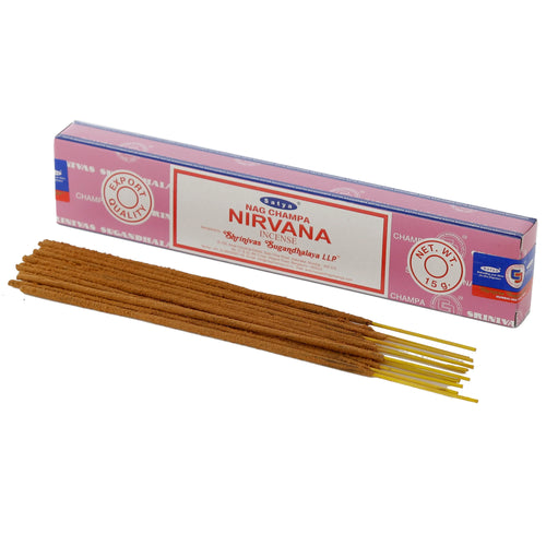 Angled view of a pink and white Nirvana Nag Champa incense stick box, with a pile of brown incense sticks, showing their yellow cores, in the foreground.