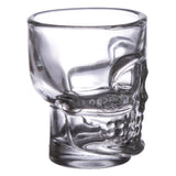 Angled view of a clear glass skull shot glass, showcasing its intricate skull design and transparent finish.