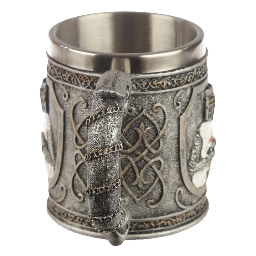 Decorative Crusader Knight Tankard, angled view showcasing its textured chain-like handle, intricate silver-grey knotwork, and a visible shield with a red cross, with a shiny metal interior.