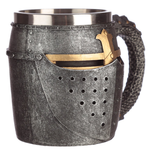 Angled view of a decorative medieval helmet tankard, with a textured grey finish, golden-coloured visor detail, perforated faceplate, chain mail textured handle, and a silver-coloured metal top rim.