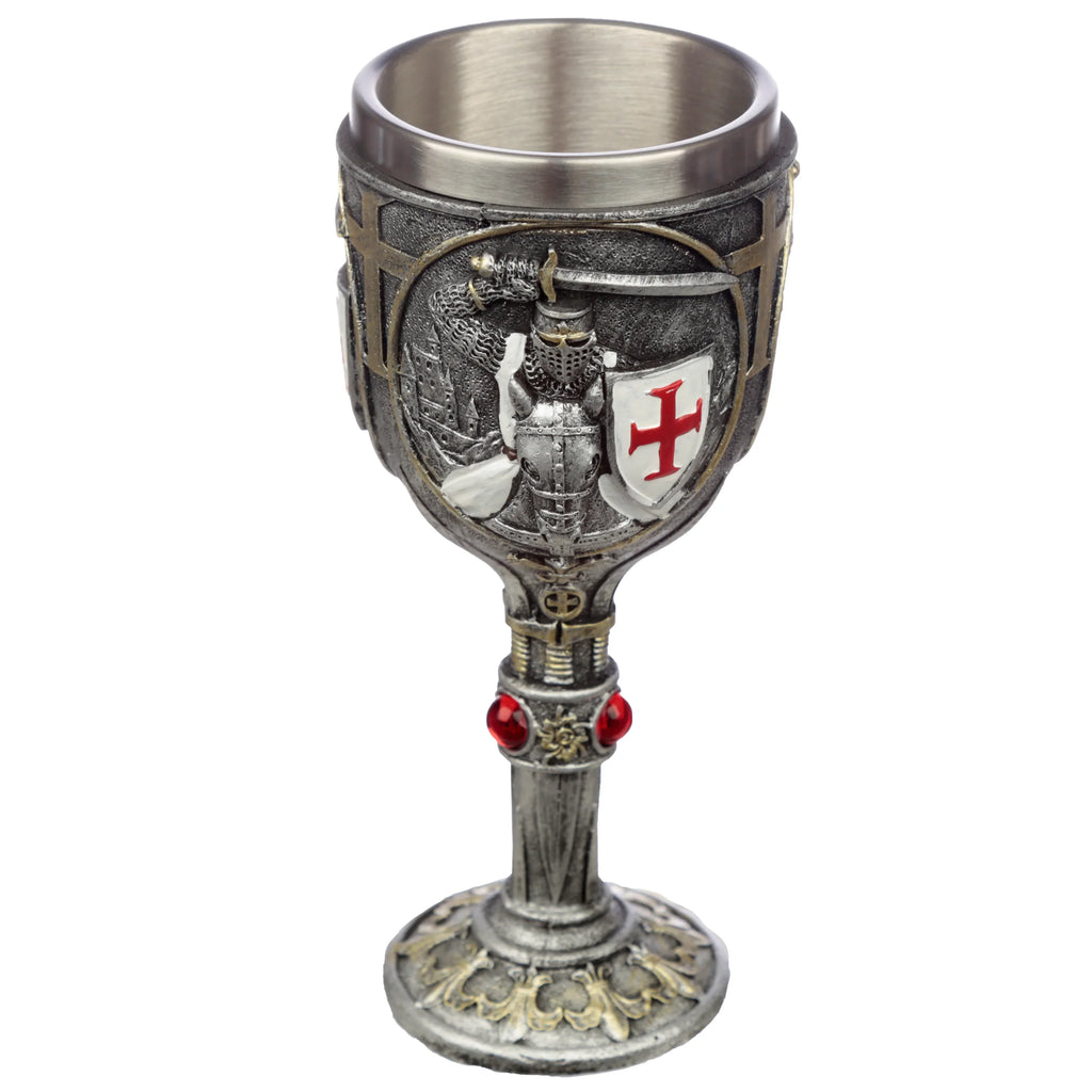 Front view of a decorative silver-grey goblet, featuring a Crusader knight with a red cross shield, a dragon, and a castle design on the cup, along with red jewels on the stem and ornate gold accents on the base.