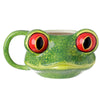 Front view of a vibrant green ceramic tree frog mug. It features large red eyes with black pupils, a textured green surface, and a matching handle on the left.
