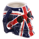 Angled view of a ceramic UK Flag skull mug, featuring a red, white, and blue Union Jack design with black eye sockets and a bone-shaped blue handle.