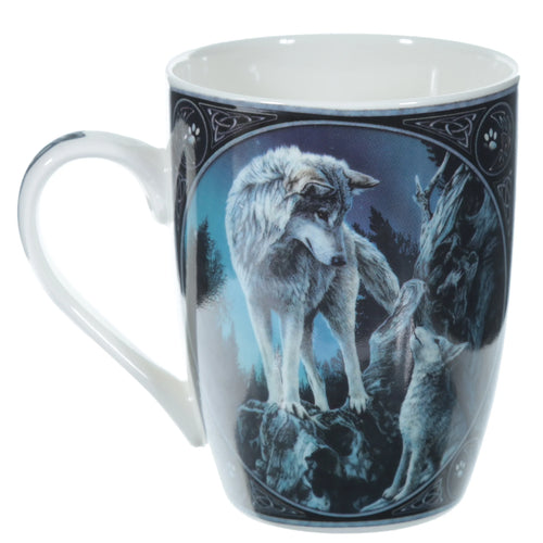 Angled view of a white porcelain mug, showcasing a blue and grey 'Guidance' wolf design. The artwork depicts a larger wolf looking at a smaller wolf on a rocky landscape with trees, encircled by a decorative border with Celtic knotwork and subtle paw prints. The mug has a white handle.