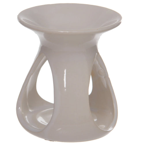 Angled view of a white ceramic oil and wax burner, featuring its tear-drop shaped cut-outs and glossy finish.